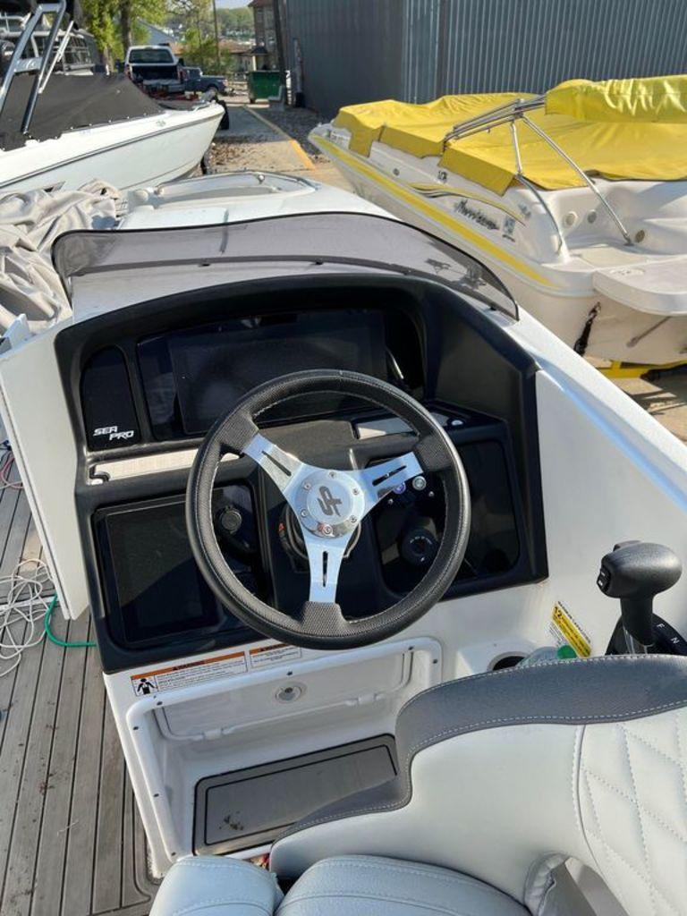 Slide: The Image of Cockpit view of a 2022 Sea Pro Citation 2400 boat with steering wheel and controls. - 1