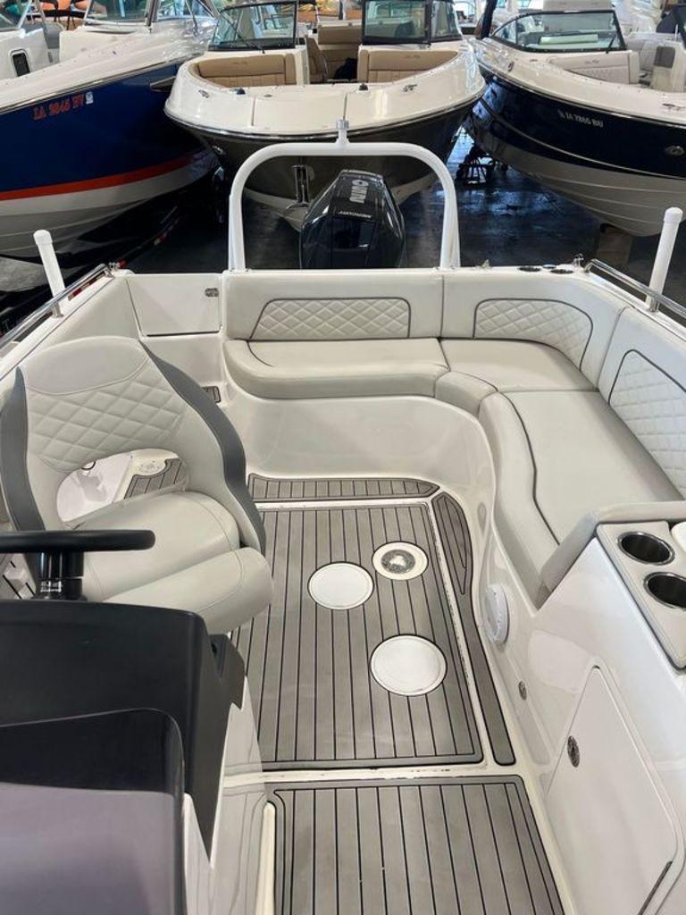 Slide: The Image of 2022 Sea Pro Citation 2400 boat interior with seating and steering wheel. - 2