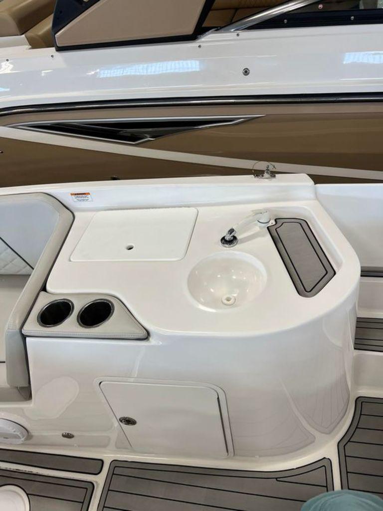 Slide: The Image of 2022 Sea Pro Citation 2400 boat interior with sink and cup holders. - 3