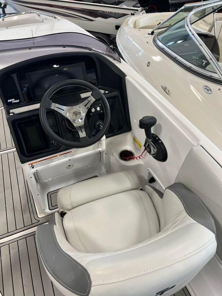 Slide: The Image of 2022 Sea Pro Citation 2400 boat cockpit with steering wheel and captain's chair. - 6