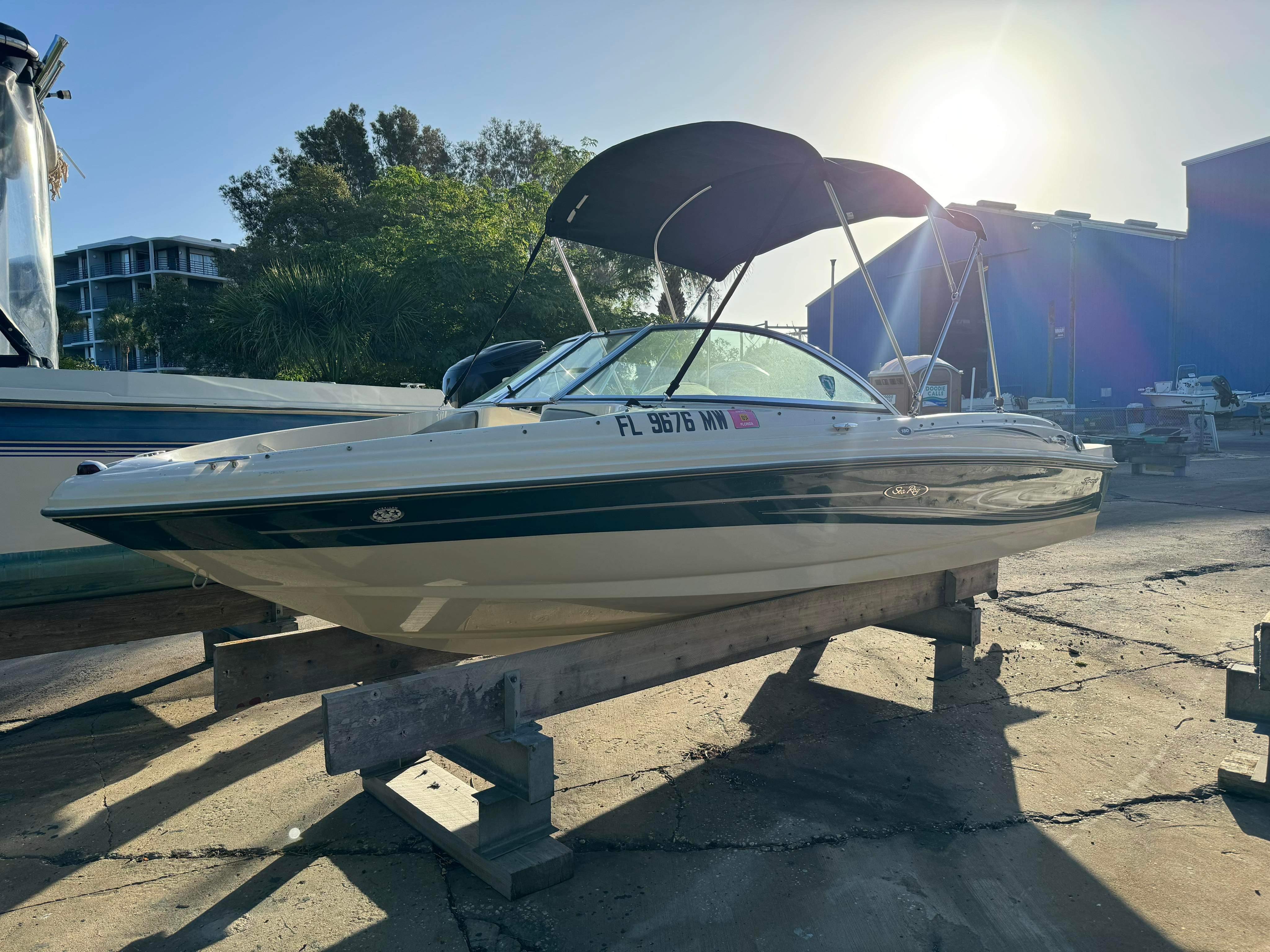 Slide: The Image of 2005 Sea Ray 180 Sport boat on a wooden stand in a marina. - 1