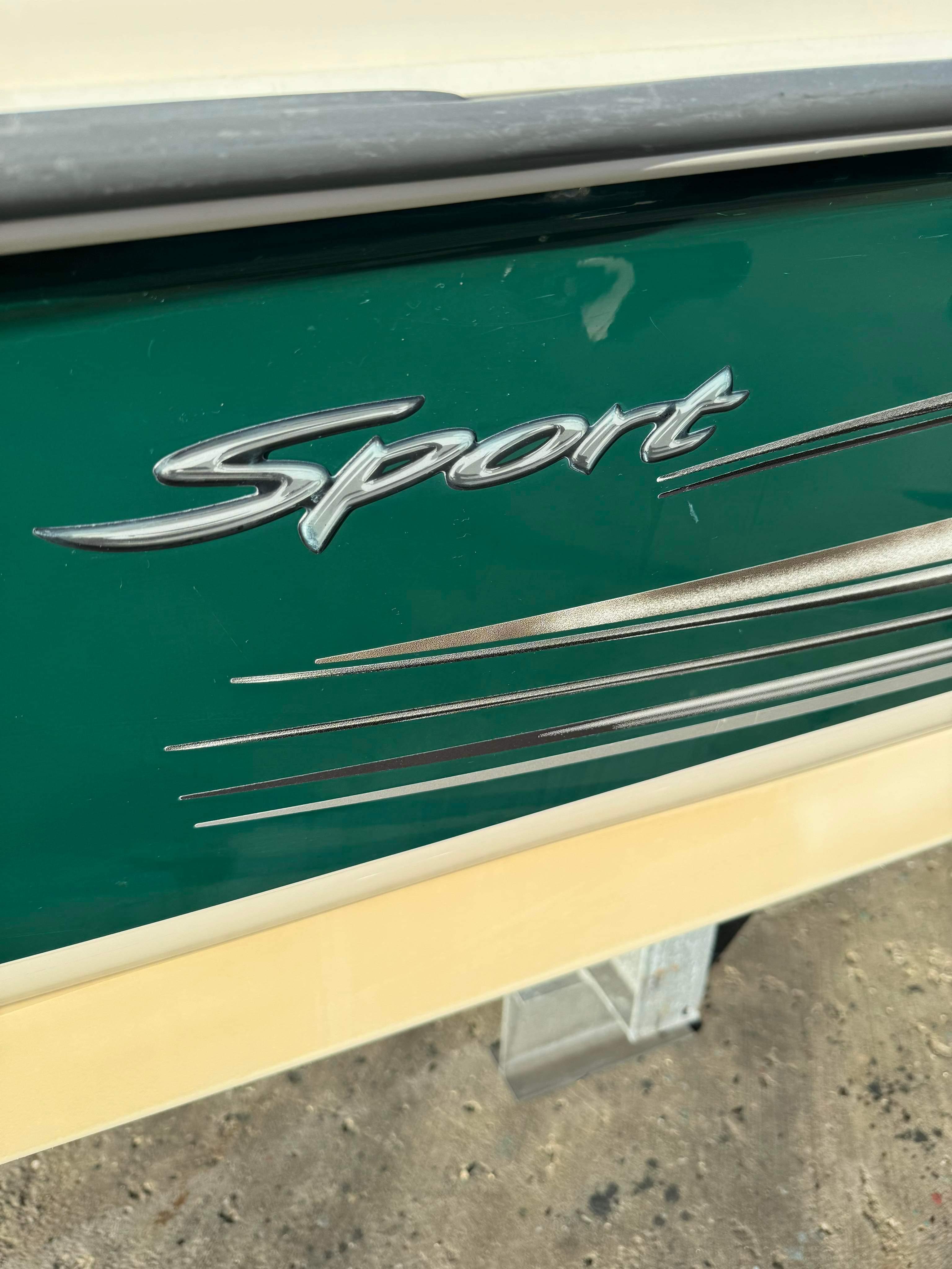 Slide: The Image of Close-up of 2005 Sea Ray 180 Sport boat logo on green hull. - 7