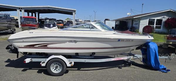 Slide: The Image of 1999 Sea Ray 185 Bow Rider boat on trailer, parked outdoors. - 1