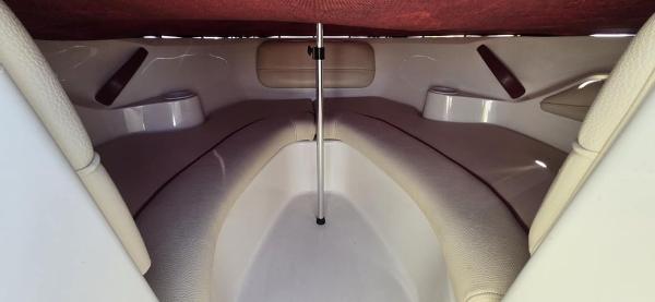 Slide: The Image of 1999 Sea Ray 185 Bow Rider interior with cushioned seating and storage compartments. - 9
