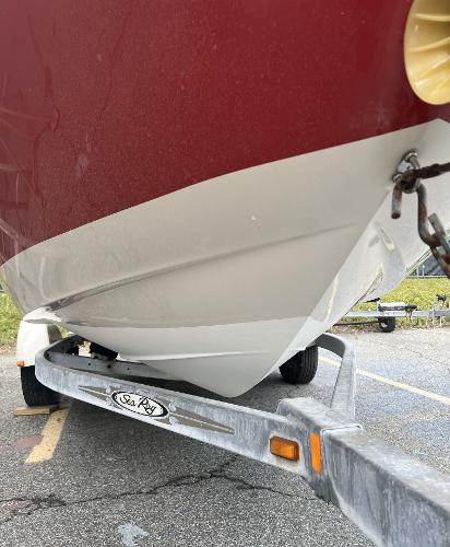Slide: The Image of 2007 Sea Ray 185 Sport boat on trailer, red and white hull, close-up view. - 4