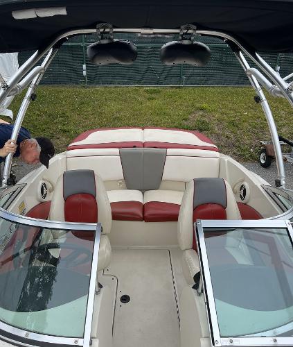 Slide: The Image of 2007 Sea Ray 185 Sport boat interior with red and gray seating, open windshield, and wakeboard tower. - 5