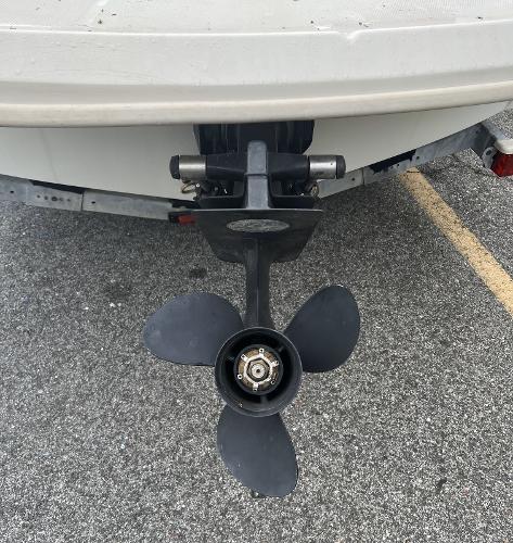 Slide: The Image of 2007 Sea Ray 185 Sport boat propeller on a trailer, parked on asphalt. - 8