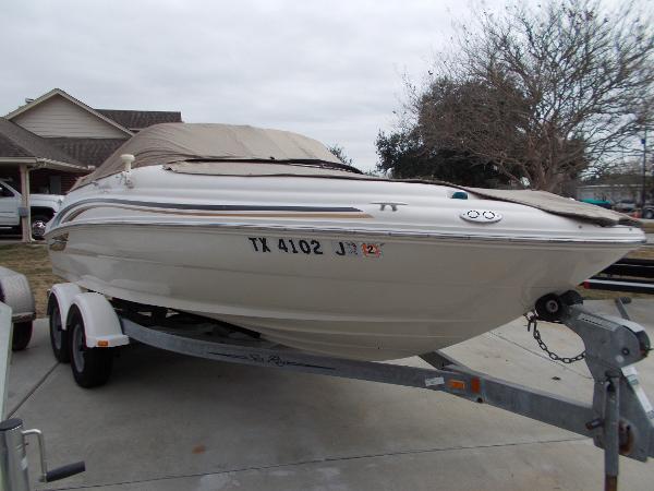 Slide: The Image of 2001 Sea Ray 190 Sundeck boat on trailer, covered and parked in driveway. - 4