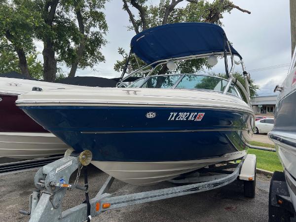 Slide: The Image of 2004 Sea Ray 200 Select boat on trailer with blue canopy. - 1