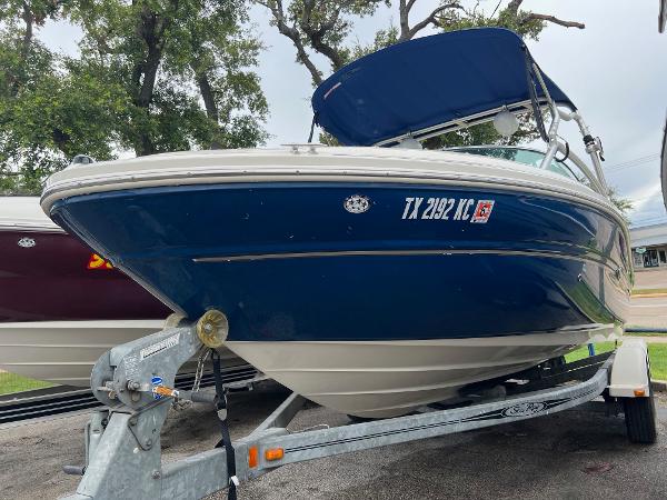 Slide: The Image of 2004 Sea Ray 200 Select boat on trailer, blue hull, parked outdoors. - 12