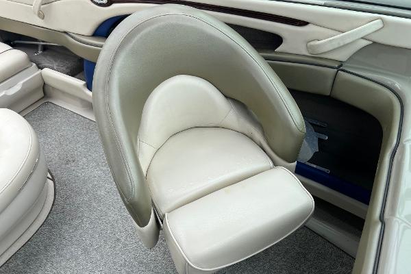 Slide: The Image of 2004 Sea Ray 200 Select boat interior with beige seating and carpeted flooring. - 13