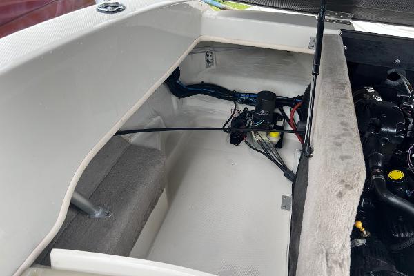 Slide: The Image of 2004 Sea Ray 200 Select boat interior storage compartment with visible wiring and engine components. - 14