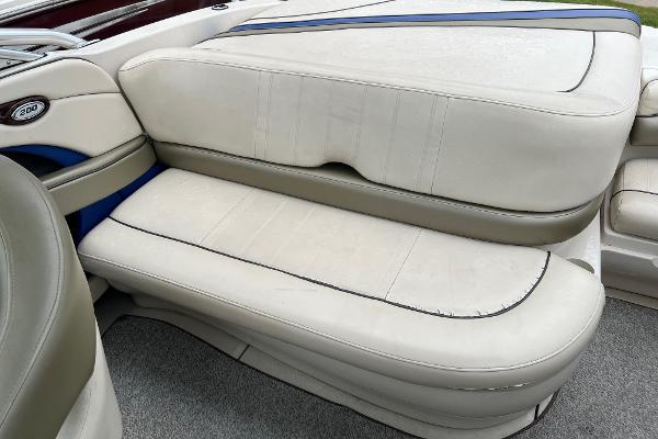 Slide: The Image of 2004 Sea Ray 200 Select boat interior seating, white upholstery with blue accents. - 16
