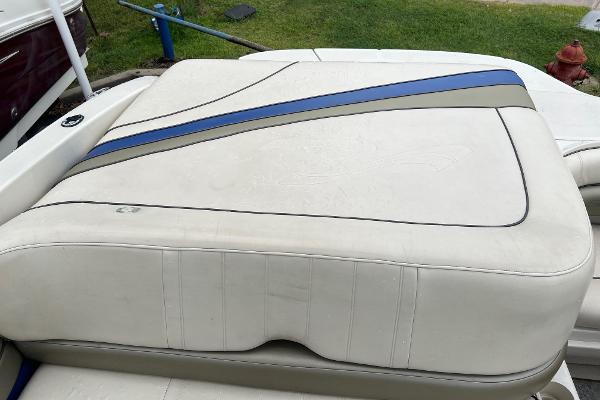 Slide: The Image of 2004 Sea Ray 200 Select boat seat with white and blue upholstery. - 17
