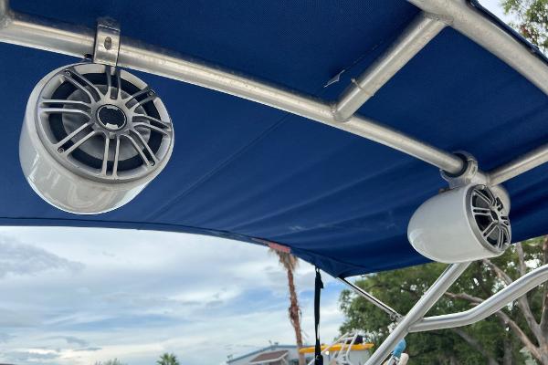 Slide: The Image of Speakers mounted on a 2004 Sea Ray 200 Select boat's blue canopy. - 18