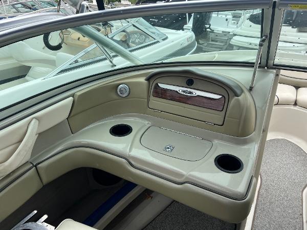 Slide: The Image of 2004 Sea Ray 200 Select boat interior with cup holders and dashboard. - 4
