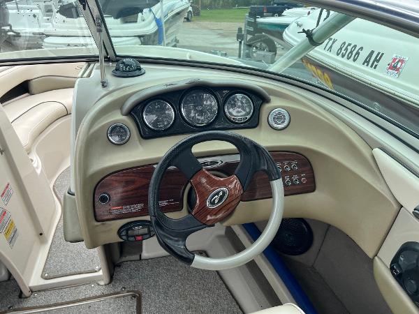 Slide: The Image of 2004 Sea Ray 200 Select boat dashboard with steering wheel and gauges. - 5