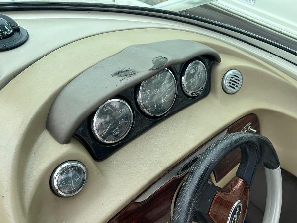Slide: The Image of Dashboard of 2004 Sea Ray 200 Select boat with gauges and steering wheel. - 6