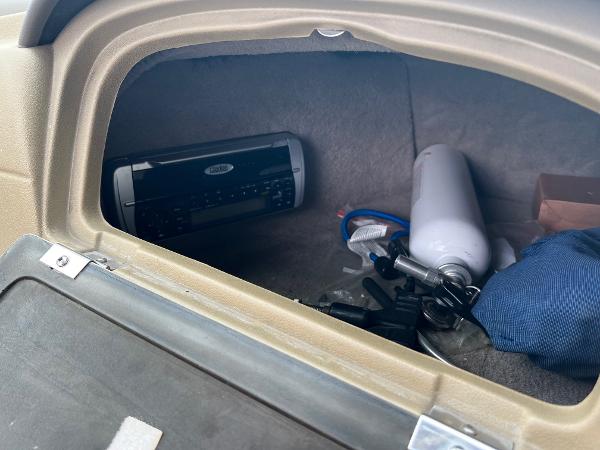 Slide: The Image of Storage compartment of a 2004 Sea Ray 200 Select boat with stereo and accessories. - 8