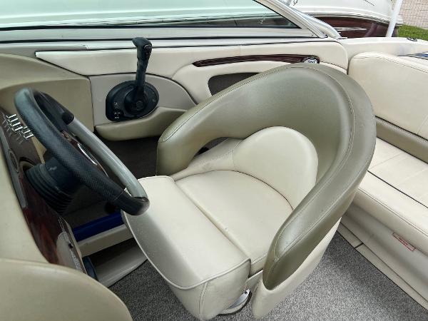 Slide: The Image of 2004 Sea Ray 200 Select boat interior with steering wheel and beige seating. - 9