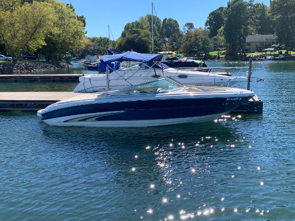 Slide: The Image of 2000 Sea Ray 210 Bow Rider boat docked on a sunny day. - 1