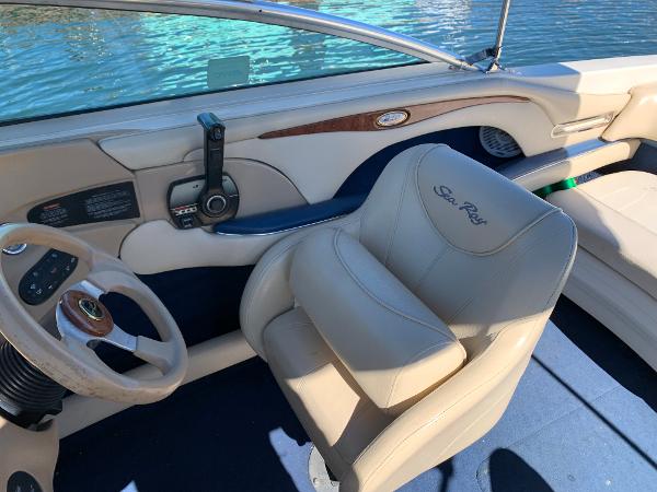 Slide: The Image of Interior of a 2000 Sea Ray 210 Bow Rider boat with steering wheel and captain's chair. - 13