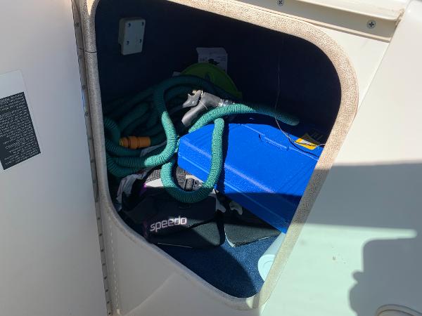 Slide: The Image of Storage compartment of a 2000 Sea Ray 210 Bow Rider with boating accessories. - 20