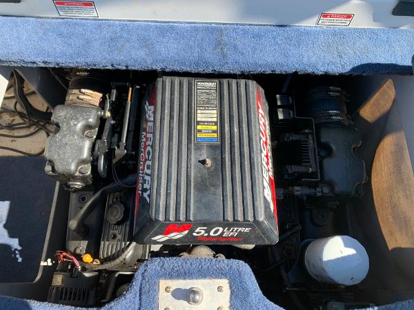 Slide: The Image of 2000 Sea Ray 210 Bow Rider engine compartment with Mercury 5.0L motor. - 24