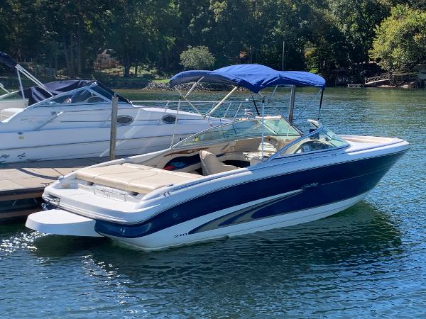 Slide: The Image of 2000 Sea Ray 210 Bow Rider boat docked on a sunny day. - 3