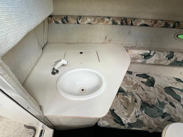 Slide: The Image of 1999 Sea Ray 215 Express Cruiser cabin sink and countertop. - 10