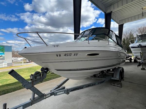 Slide: The Image of 1999 Sea Ray 215 Express Cruiser on a trailer under a canopy. - 3