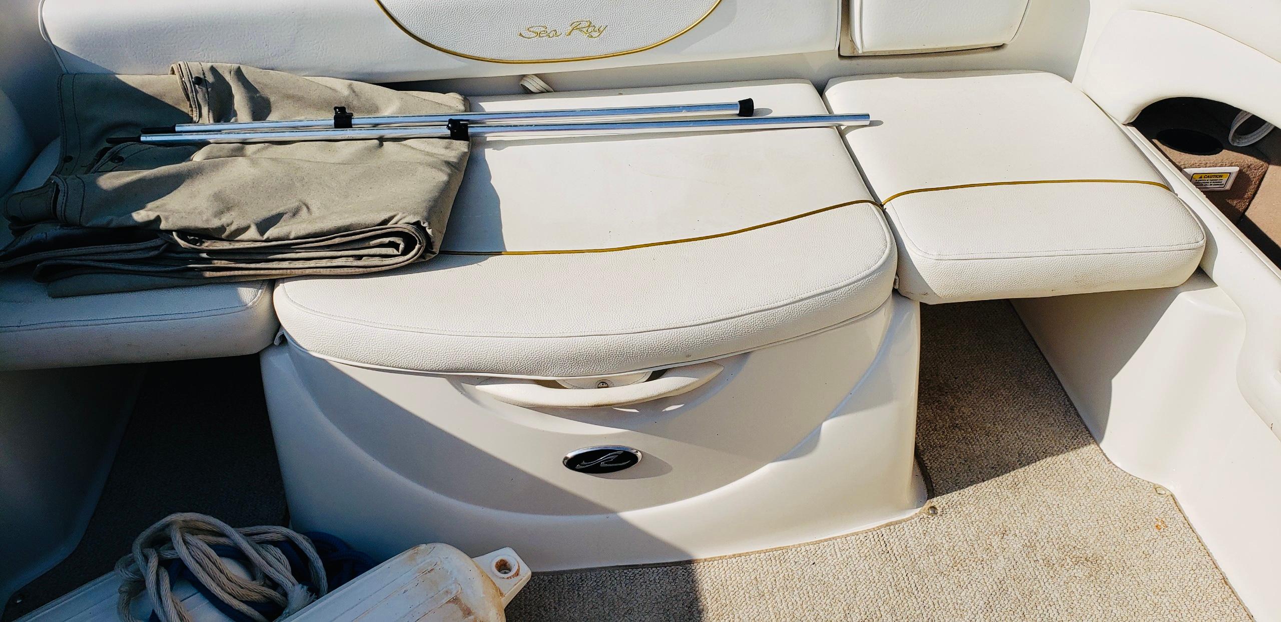 Slide: The Image of Interior seating of 2001 Sea Ray 225 Weekender boat with storage and accessories. - 4