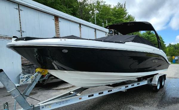 Slide: The Image of 2024 Sea Ray 230 SPX boat on a trailer, black and white exterior. - 2