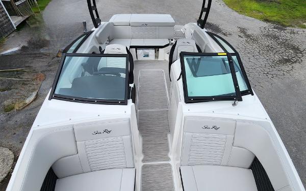 Slide: The Image of 2024 Sea Ray 230 SPX boat interior with white seating and dual windshields. - 8