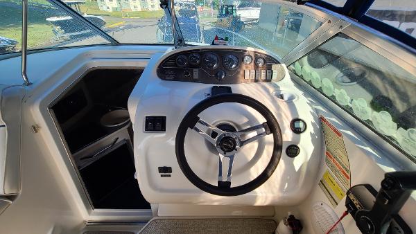Slide: The Image of 1996 Sea Ray 240 Sundancer boat helm with steering wheel and instrument panel. - 11