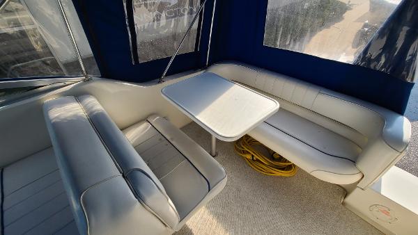 Slide: The Image of Interior seating area of a 1996 Sea Ray 240 Sundancer boat with table. - 12