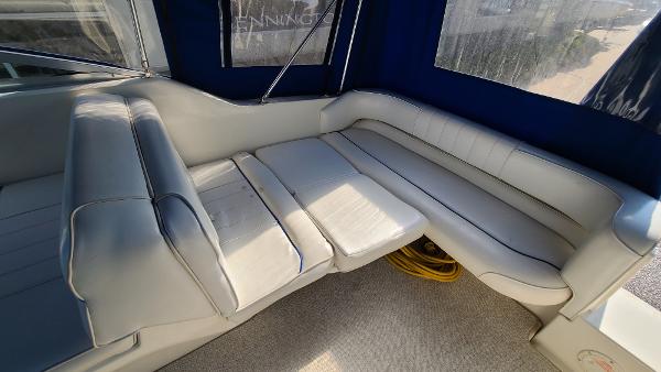 Slide: The Image of Interior seating of a 1996 Sea Ray 240 Sundancer boat with white upholstery. - 13