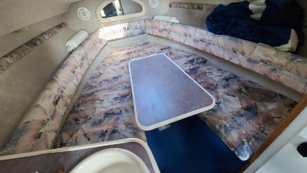 Slide: The Image of Interior cabin of a 1996 Sea Ray 240 Sundancer with patterned seating and table. - 16