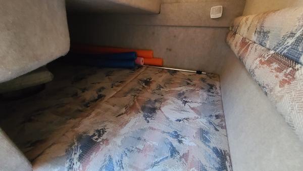 Slide: The Image of Interior cabin of a 1996 Sea Ray 240 Sundancer boat with patterned upholstery. - 18