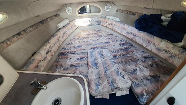 Slide: The Image of 1996 Sea Ray 240 Sundancer cabin interior with sink and patterned upholstery. - 20