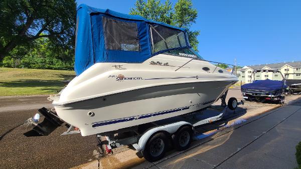 Slide: The Image of 1996 Sea Ray 240 Sundancer boat on a trailer with blue canopy. - 3