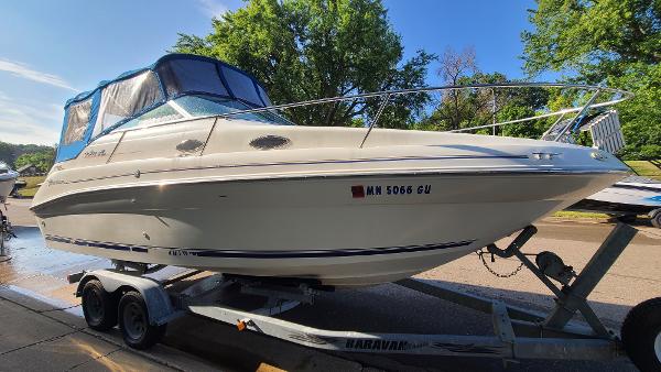 Slide: The Image of 1996 Sea Ray 240 Sundancer boat on a trailer, ready for transport. - 4