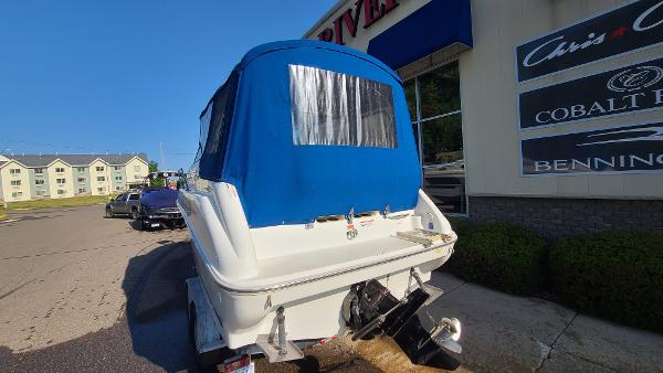 Slide: The Image of 1996 Sea Ray 240 Sundancer boat with blue canvas cover on trailer. - 5