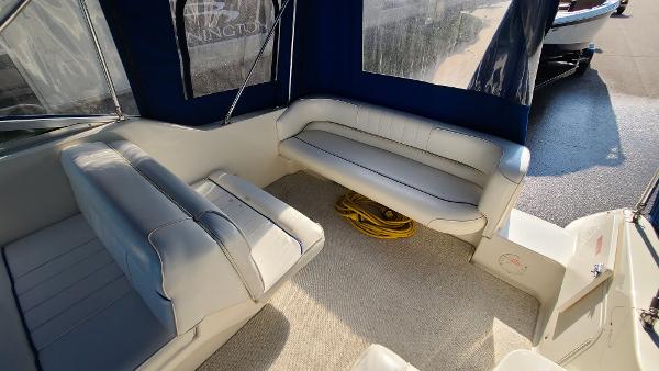 Slide: The Image of Interior seating area of a 1996 Sea Ray 240 Sundancer boat with blue and white upholstery. - 7