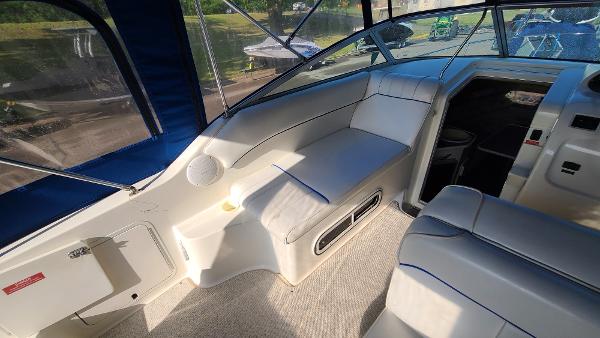 Slide: The Image of 1996 Sea Ray 240 Sundancer boat interior with seating and helm station. - 8