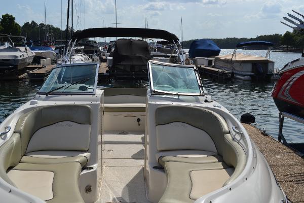 Slide: The Image of 2005 Sea Ray 240 Sundeck boat docked at a marina with other boats. - 5