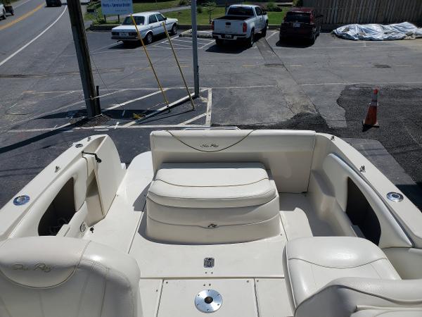 Slide: The Image of 2001 Sea Ray 245 Weekender boat interior with white seating and open deck area. - 2