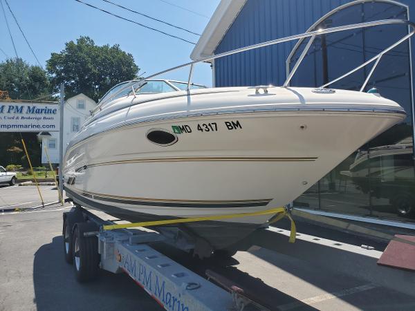 Slide: The Image of 2001 Sea Ray 245 Weekender boat on trailer at marina. - 5