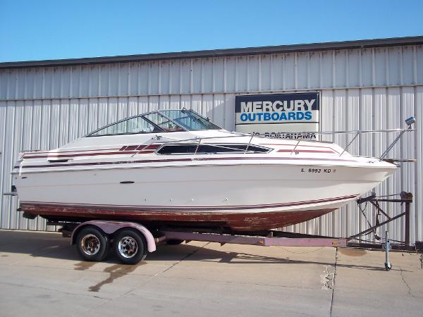 Slide: The Image of 1984 Sea Ray SRV 260 Sundancer boat on trailer outside Mercury Outboards building. - 2