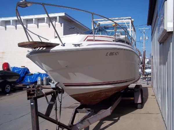 Slide: The Image of 1984 Sea Ray SRV 260 Sundancer on trailer in marina. - 7